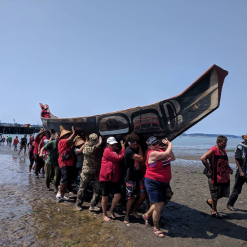 Power Paddle to Puyallup, 2018. After landing, each canoe was carried above the high tide line by up to 50 volunteers.
