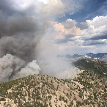 Smoke billows from a forested ridge during the 2017 Ibex Fire